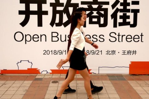 Residents in Beijing pass a new international commercial business street on September 19. Photo: Stephen Shaver/UPI