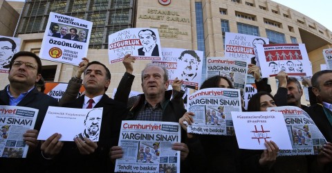 Demonstrators hold copies of Cumhuriyet outside the court where several of the newspaper's employees were on trial in 2017. Photo: Lefteris Pitarakis / AP