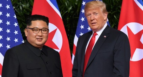 Standing in front of the flags of their two countries, Donald Trump and Kim Jong Un made history in Singapore. Photo: Saul Loeb / AFP