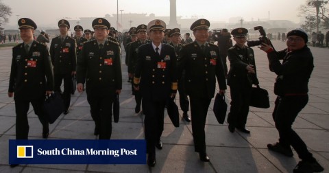 Military delegates arrive at the Great Hall of the People for the National People’s Congress on Tuesday