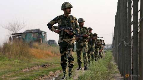 India's Border Security Force (BSF) soldiers patrol along the fenced border with Pakistan in Ranbir Singh Pura sector near Jammu.