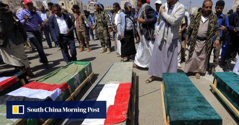 Yemenis gather around the coffins of schoolchildren during a funeral in the capital Sanaa on April 10.