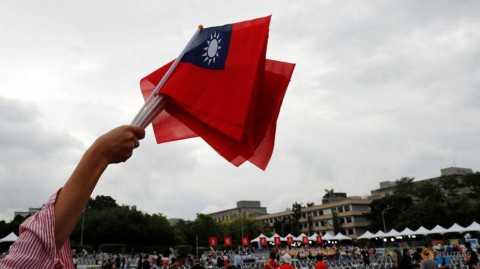 An audience waves Taiwanese flags during the National Day celebrations in Taipei, Taiwan.