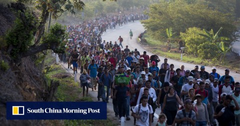 Central American migrants, part of a caravan hoping to reach the US border, move on the road in Escuintla, Chiapas State, Mexico. 