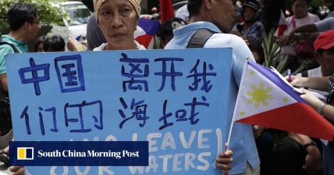 A protester outside the Chinese consulate in Manila calls for China to leave Philippine waters.