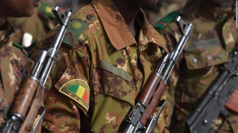 Malian troops stand guard prior to the visit of the French Prime Minister.