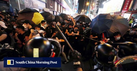 Protesters clash with police officers in Shan Tung Street in Mong Kok on Sunday night. 