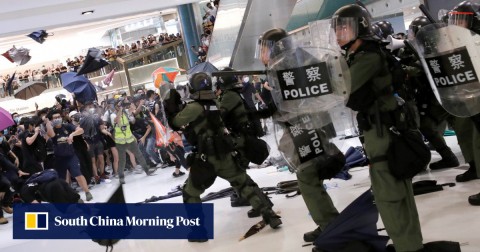 Riot police use pepper spray to disperse pro-democracy activists inside New Town Plaza mall. 