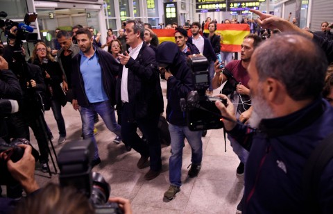 Sacked Catalan government hit with insults as they land in Barcelona