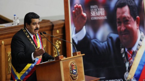 Venezuela's President Nicolas Maduro, left, speaks next to a framed poster featuring the late President Hugo Chavez, during the annual state-of-the-nation address at the National Assembly in Caracas, Venezuela, Jan. 21, 2015. Photo: AP