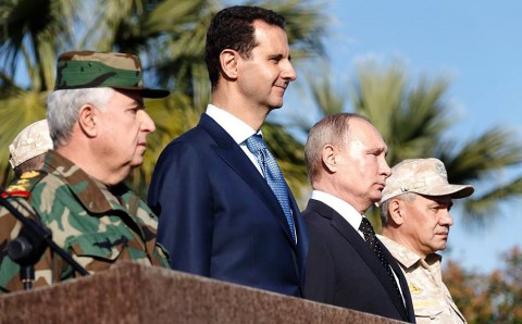 Bashar al-Assad and Vladimir Putin inspect a military parade in the northwestern Syrian province of Latakia. AFP/Getty Images
