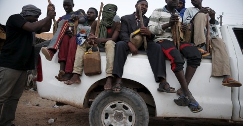 Migrants sit in the back of a truck at a local immigration transit center in Agadez, Niger, in May 2015. Photo: Akintunde Akinleye
