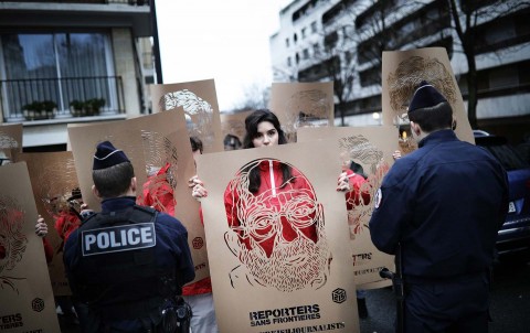 Members of Reporters without Borders (RSF) hold stencils representing portraits of imprisoned Turkish journalists during a demonstration in front of the Turkish embassy in Paris, January 5, 2018. Photo: Sipa via AP Images