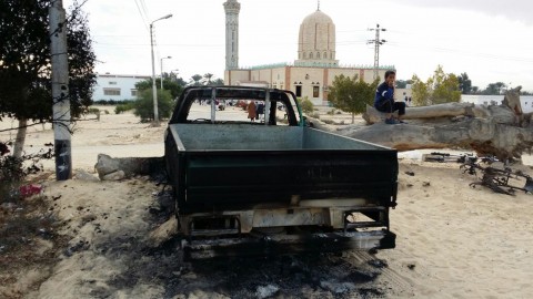A burned truck is seen outside Al-Rawda Mosque in Bir al-Abd northern Sinai a day after attackers killed hundreds of worshippers. Photo: Tarek Samy / AP