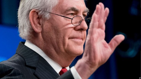 Secretary of State Rex Tillerson waves goodbye at the State Department in 