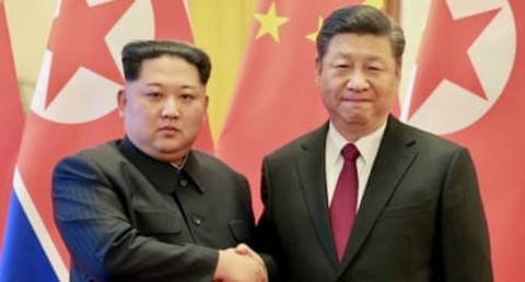 Kim Jong-un and Xi Jin-ping shake hands in an appearance during Kim’s low-key visit to Beijing. Photo: Al Jazeera