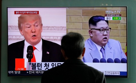 A man watches a TV screen showing file footages of US President Donald Trump, left, and North Korean leader Kim Jong Un, right, during a news program at the Seoul Railway Station in Seoul, South Korea. Photo: Lee Jin-man / AP