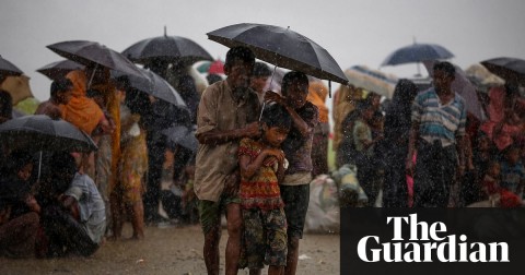  Rohingya refugees shelter from torrential rain after crossing the border into Bangladesh. Photo: Mohammad Ponir Hossain/Reuters