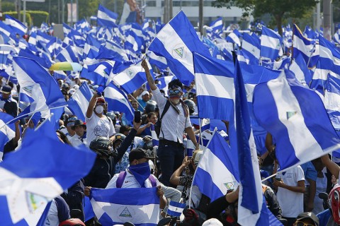 Anti-government protesters wave Nicaraguan flags in Managua on May 9, 2018. Nicaraguans took to the streets Wednesday in one of the largest protest marches so far against President Daniel Ortega’s administration. Photo: Alfredo Zuniga / AP