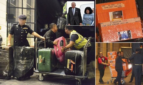 Police load confiscated items into a truck in Kuala Lumpur, Malaysia. They included 72 suitcases containing cash, jewelry and other valuables. Photo: AP