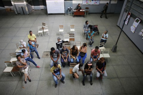 People wait their turn to vote during the presidential election in Caracas