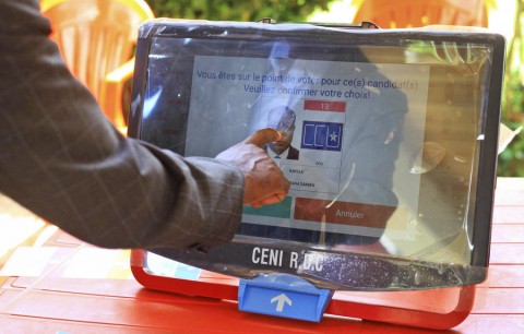 A man demonstrates how to vote with an electronic machine that will be used in Congo’s upcoming election in Beni, Congo, on Oct. 16. Photo: Al-hadji Kudra Maliro / AP